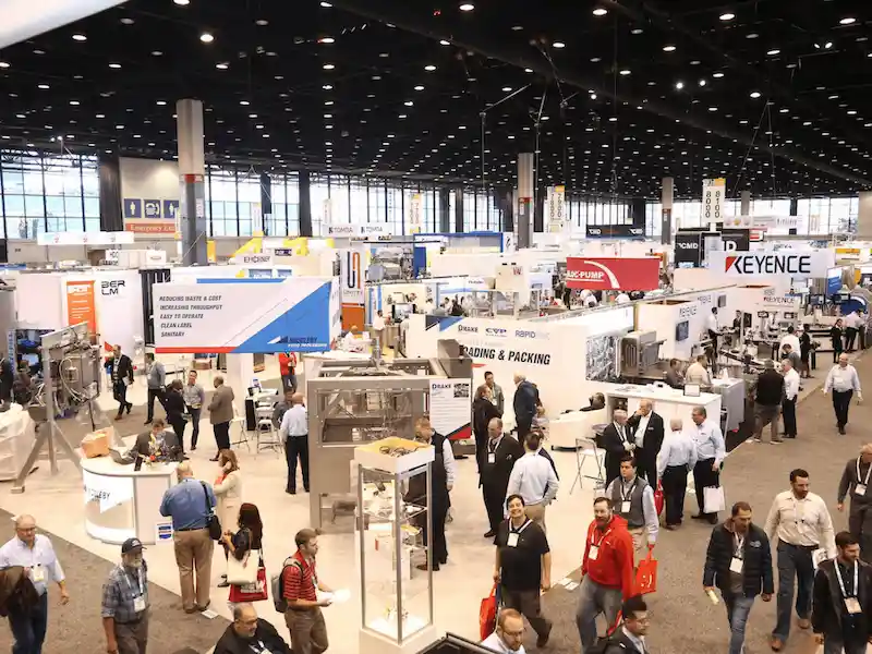 Packed exhibit hall of machinery stands at a Chicago trade show