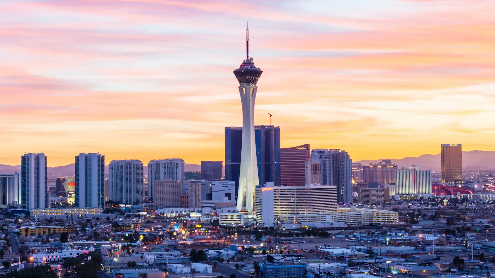 Las Vegas skyline at sunset with the STRAT Tower and surrounding cityscape