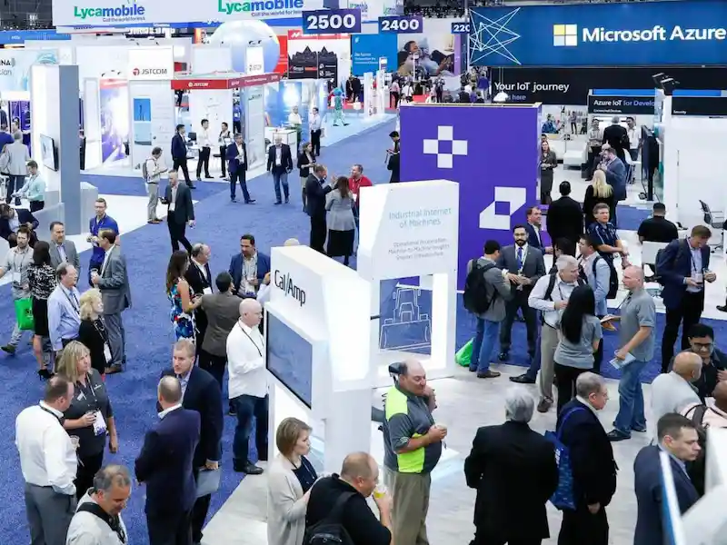Busy Los Angeles trade show floor with technology exhibition booths and attendees