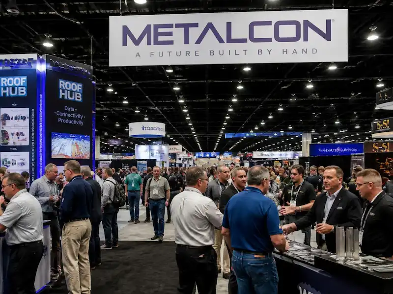 Busy Orlando trade show floor with Metalcon exhibition booths and attendees