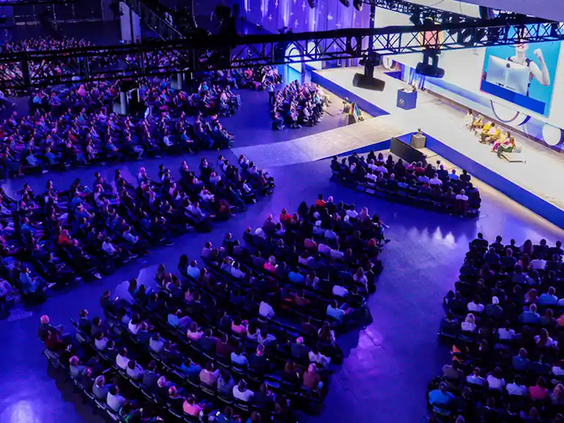 Audience seated for a keynote session in a large conference hall