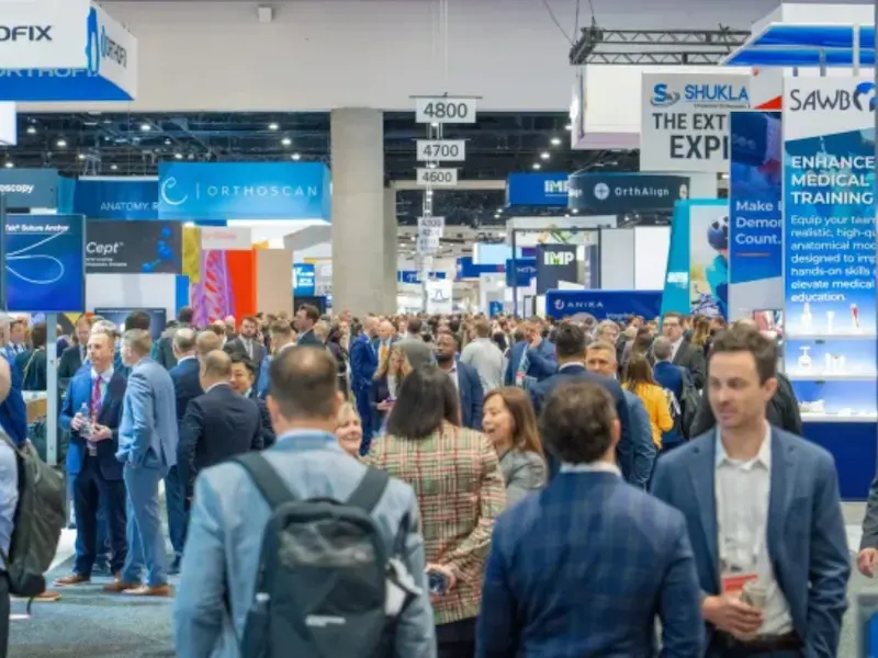 Crowded aisle of medical exhibitor booths at a San Diego trade show